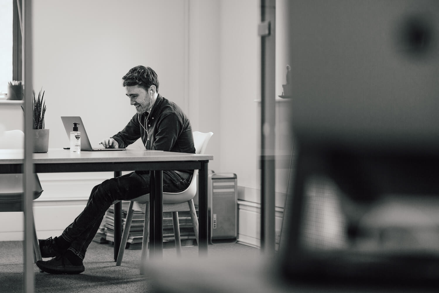 Photo of our Managing Director on a video call in meeting room